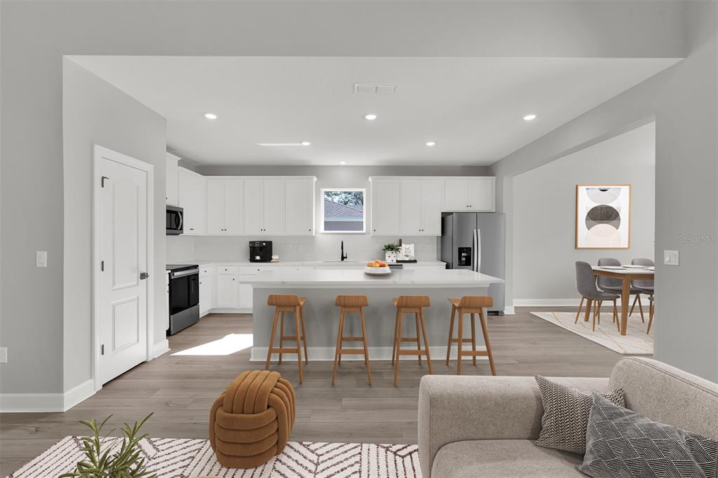 4451 Southwest 160 Loop Ocala, FL 34473 - Photo 8 of 15 a living room with furniture a table and kitchen view