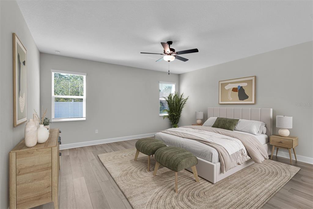 4451 Southwest 160 Loop Ocala, FL 34473 - Photo 10 of 15 a bedroom with a large bed and a chandelier