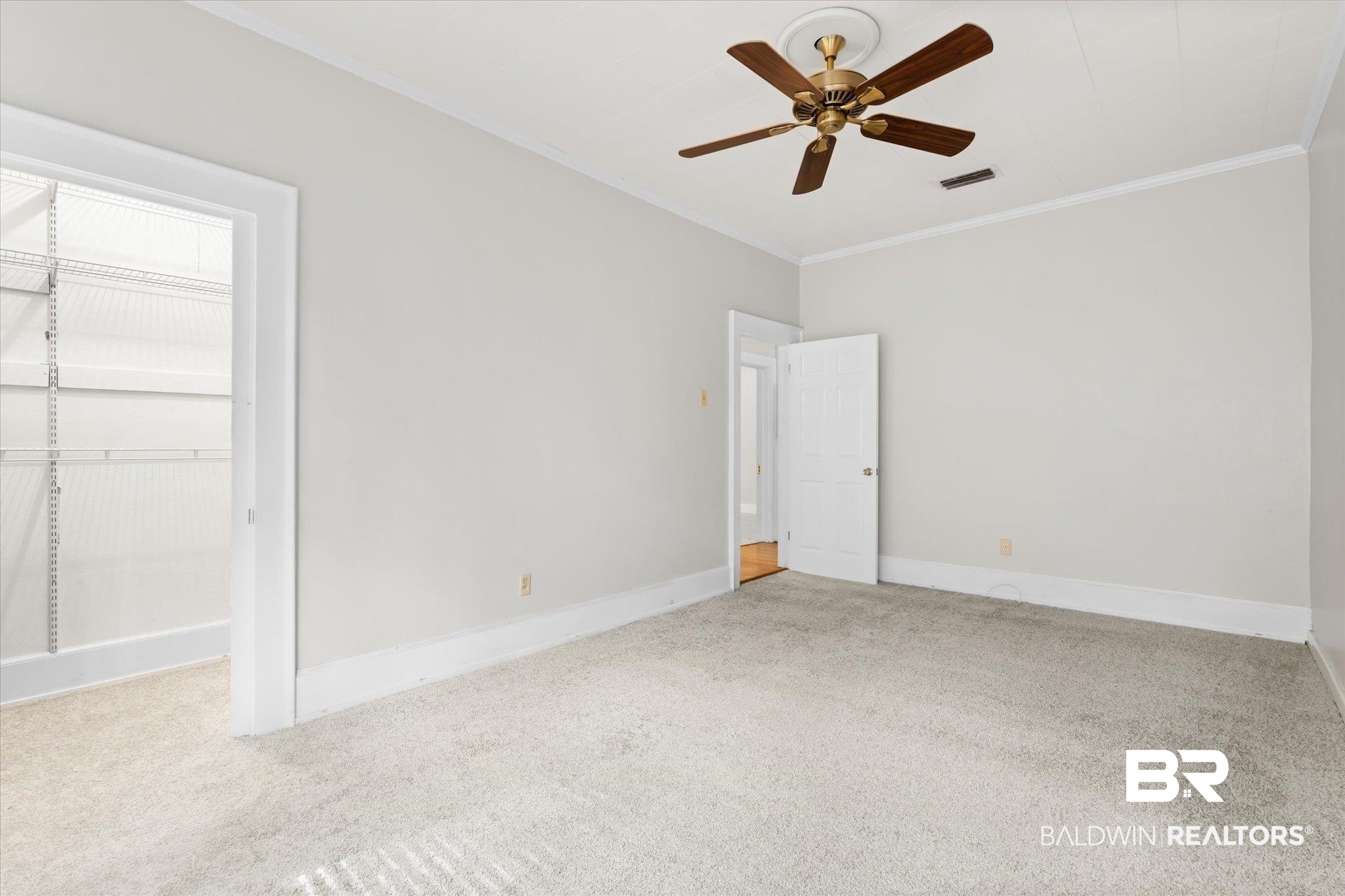 211 3rd Street Mobile, AL 36611 - Photo 10 of 20 Unfurnished bedroom with ornamental molding, light carpet, and ceiling fan