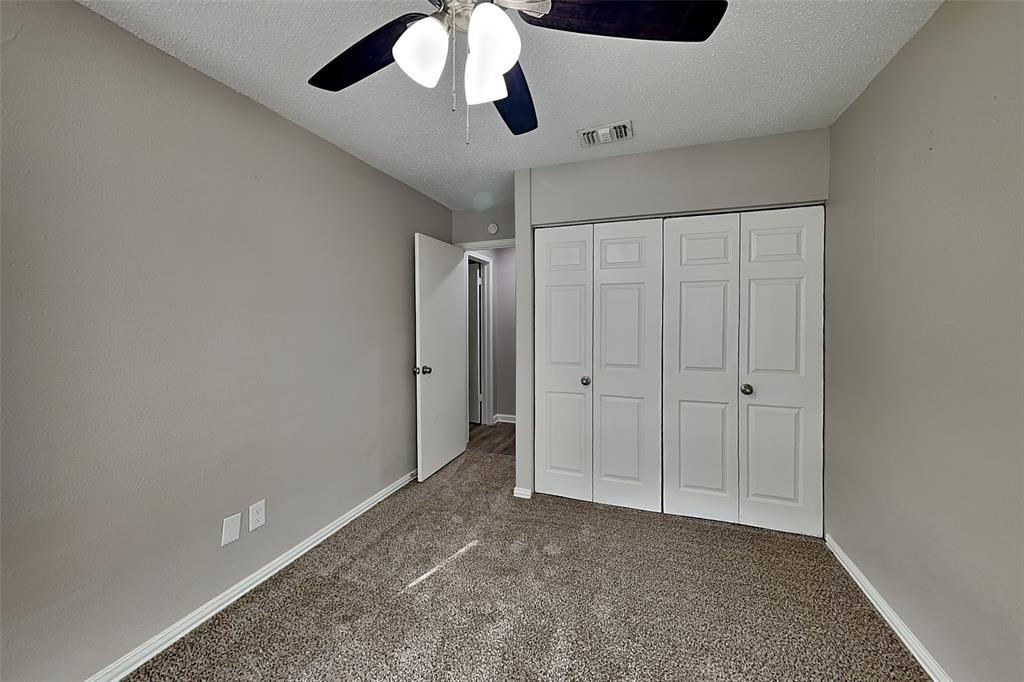 4649 Birchbend Lane Fort Worth, TX 76137 - Photo 13 of 18 an empty room with a ceiling fan and carpet