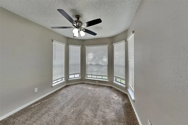 a white toilet sitting next to a bath tub