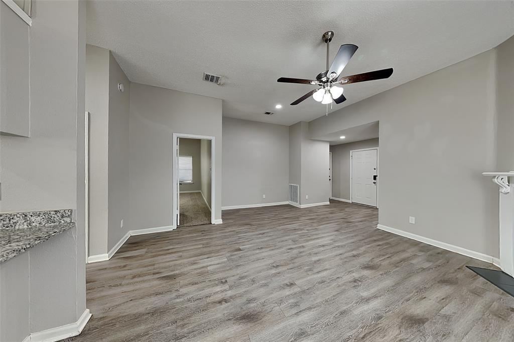 4649 Birchbend Lane Fort Worth, TX 76137 - Photo 2 of 18 a view of an empty room and window with a ceiling fan