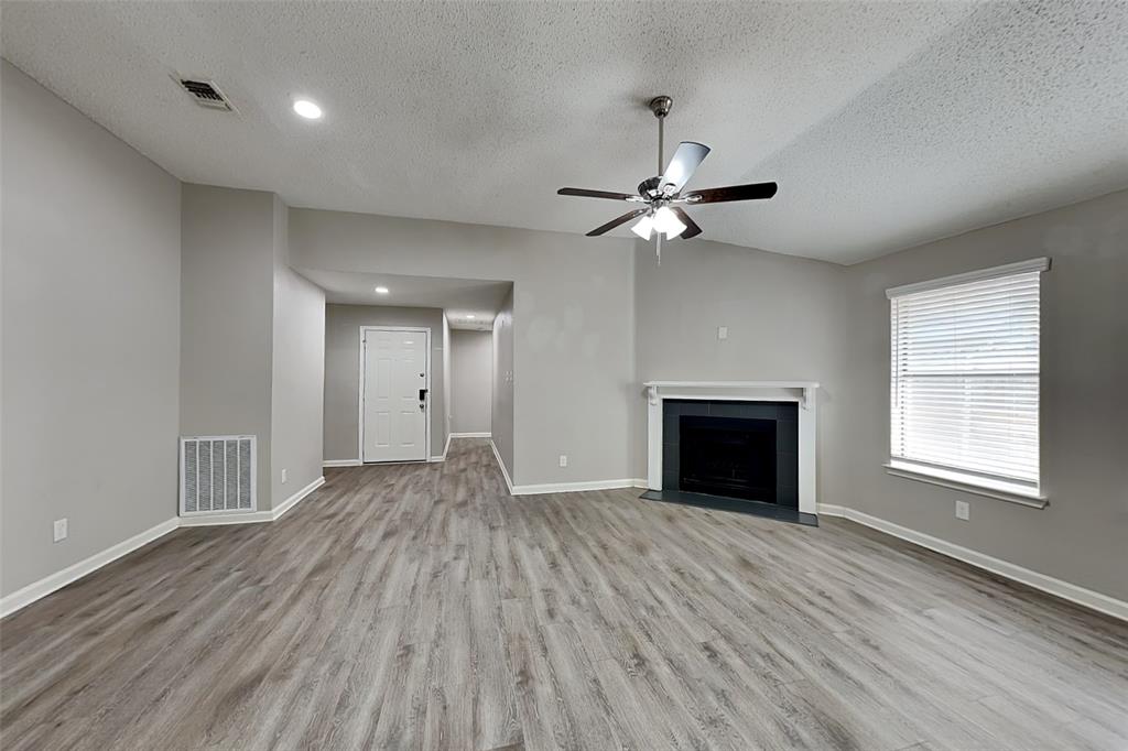 4649 Birchbend Lane Fort Worth, TX 76137 - Photo 3 of 18 a view of an empty room with a fireplace and a window