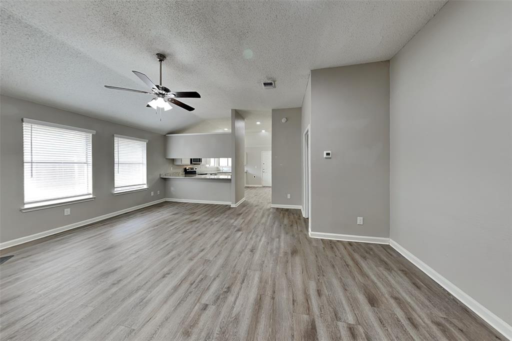 4649 Birchbend Lane Fort Worth, TX 76137 - Photo 4 of 18 a view of empty room with wooden floor and window