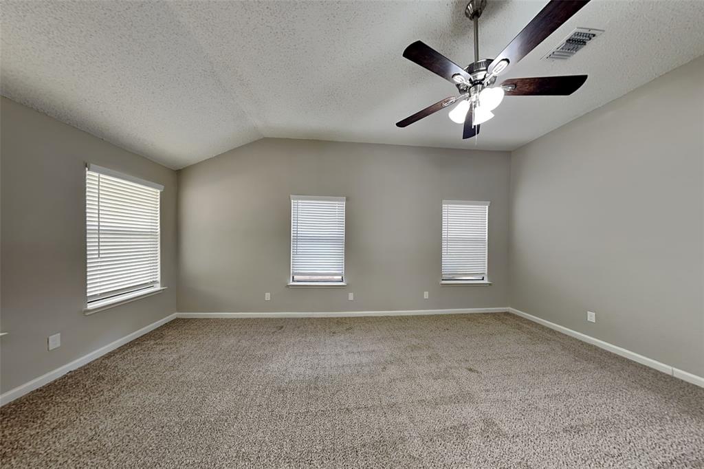 4649 Birchbend Lane Fort Worth, TX 76137 - Photo 8 of 18 an empty room with windows and fan
