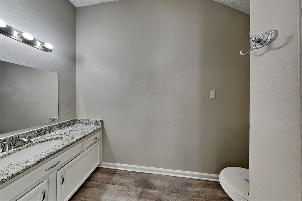 4649 Birchbend Lane Fort Worth, TX 76137 - Photo 10 of 18 a bathroom with a granite countertop sink and a toilet
