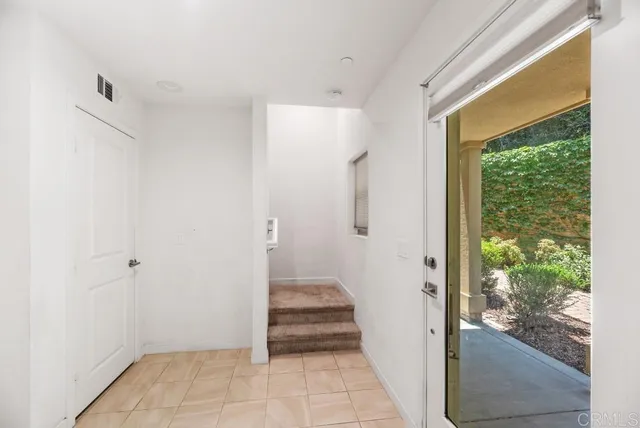 a view of an entryway with wooden floor and door