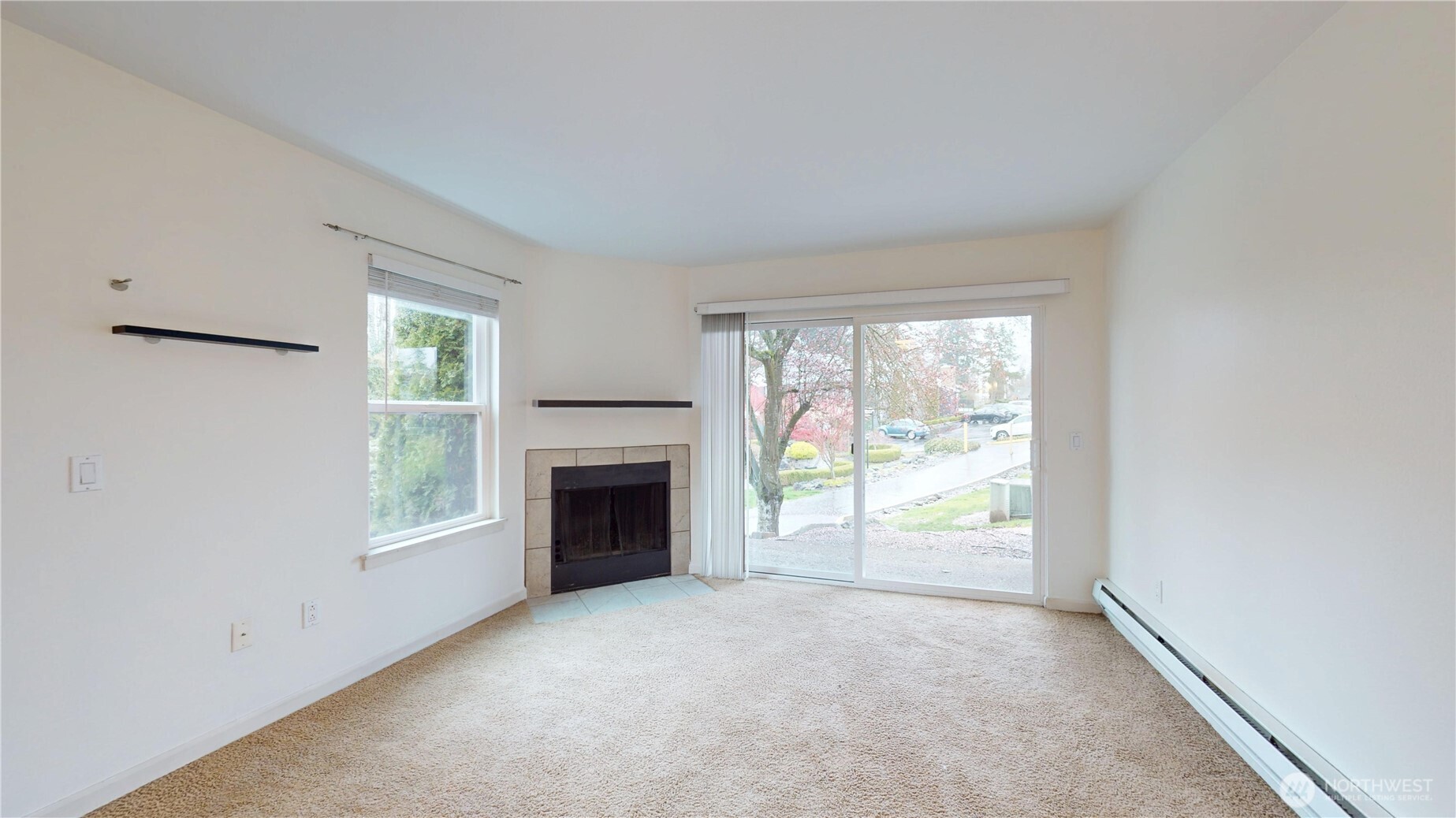 2613 South 272nd Street, Unit 21 Kent, WA 98032 - Photo 2 of 19 a view of an empty room with a window and fire place