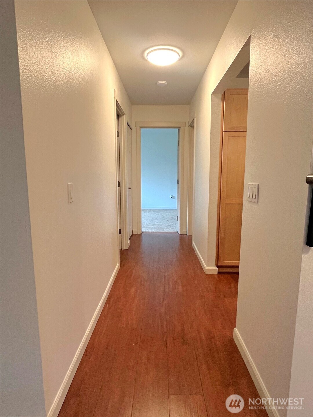 2613 South 272nd Street, Unit 21 Kent, WA 98032 - Photo 7 of 19 a view of hallway with wooden floor