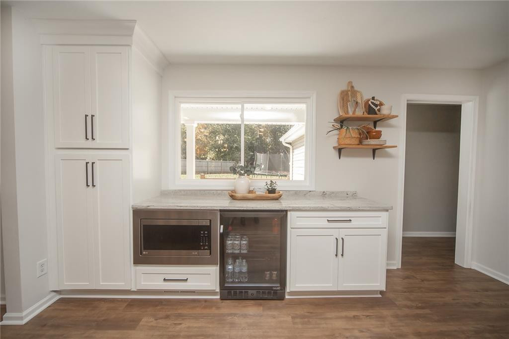 2741 Creek Point Road Graham, NC 27253 - Photo 12 of 36 a kitchen with stainless steel appliances granite countertop a sink and cabinets with wooden floor