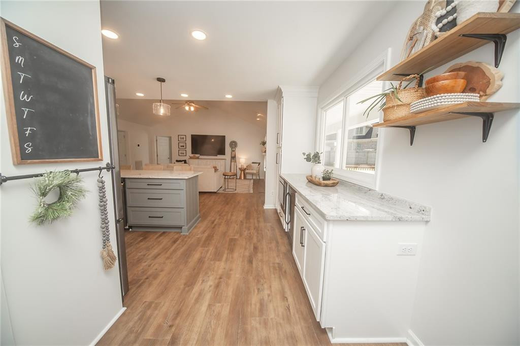 2741 Creek Point Road Graham, NC 27253 - Photo 13 of 36 a kitchen with stainless steel appliances granite countertop a sink and cabinets