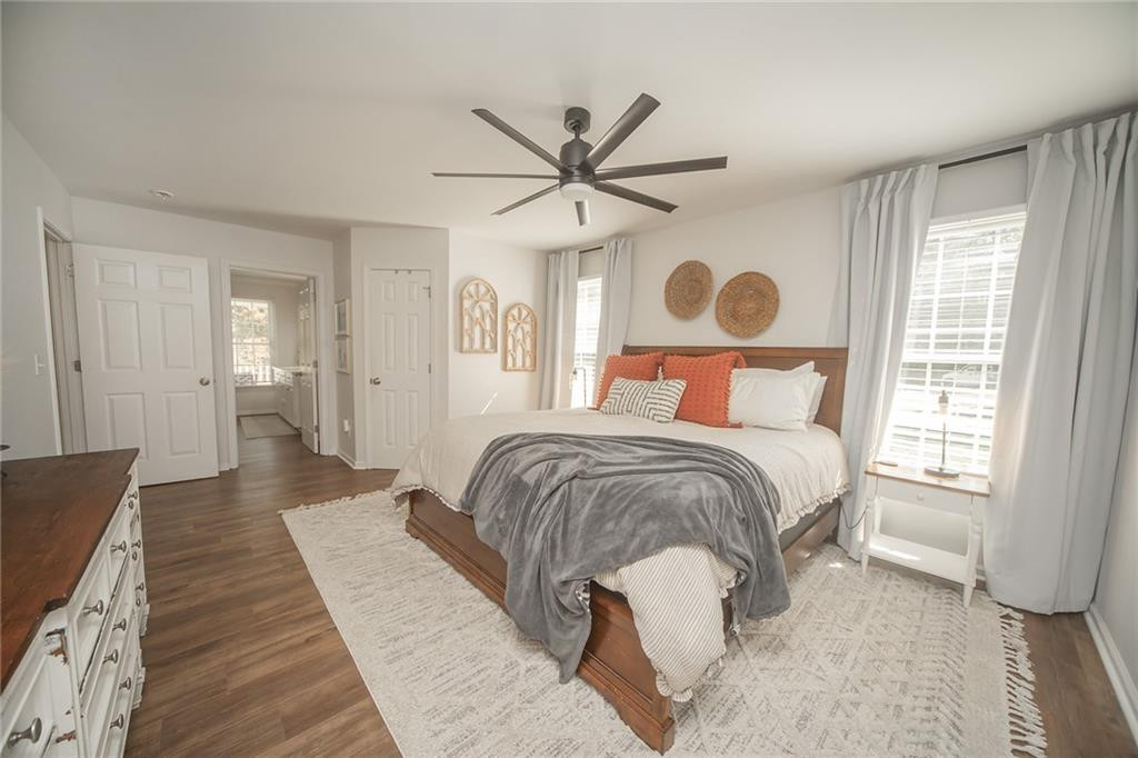 2741 Creek Point Road Graham, NC 27253 - Photo 15 of 36 a bedroom with a large bed and a chandelier