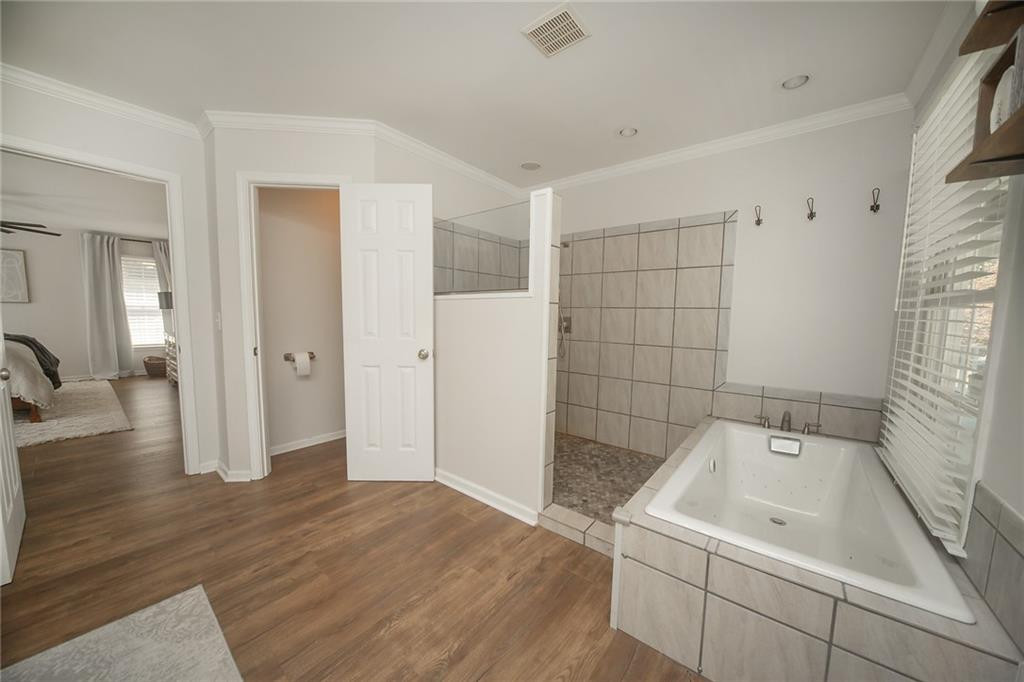 2741 Creek Point Road Graham, NC 27253 - Photo 17 of 36 a bathroom with a bathtub and sink