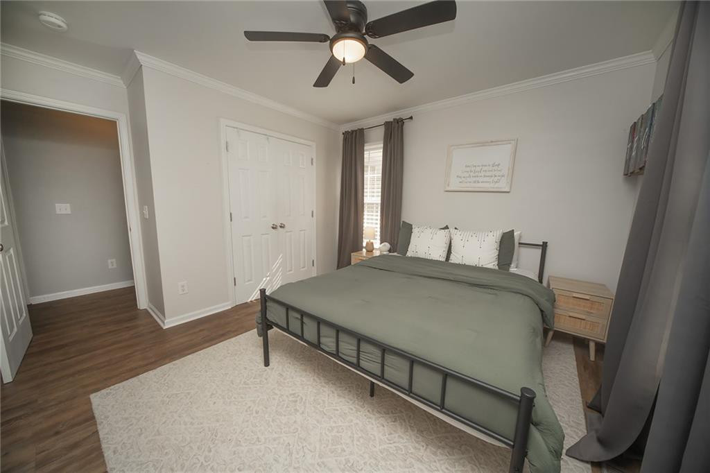 2741 Creek Point Road Graham, NC 27253 - Photo 18 of 36 a bedroom with a bed and wooden floor