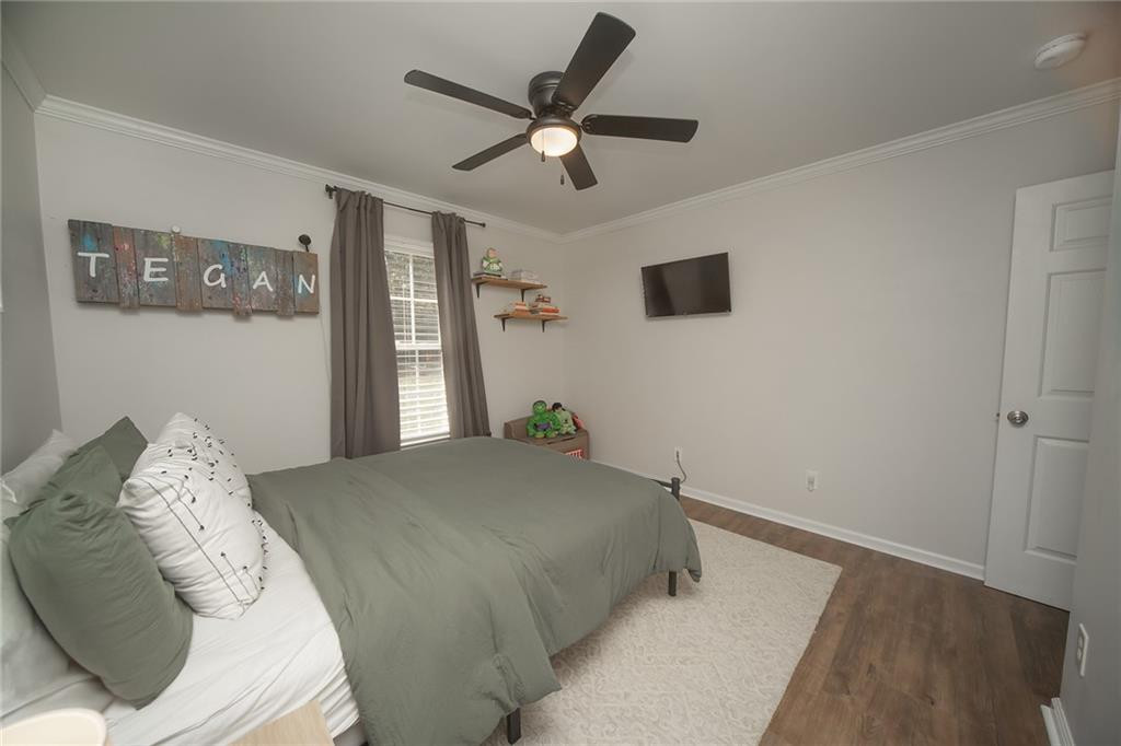 2741 Creek Point Road Graham, NC 27253 - Photo 19 of 36 a bedroom with a large bed and a ceiling fan