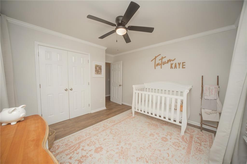 2741 Creek Point Road Graham, NC 27253 - Photo 22 of 36 a bedroom with a bed and a chandelier