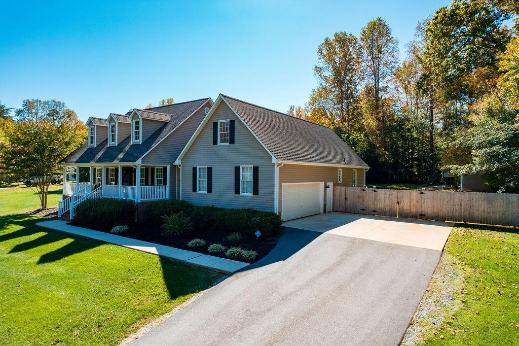2741 Creek Point Road Graham, NC 27253 - Photo 28 of 36 a front view of a house with garden