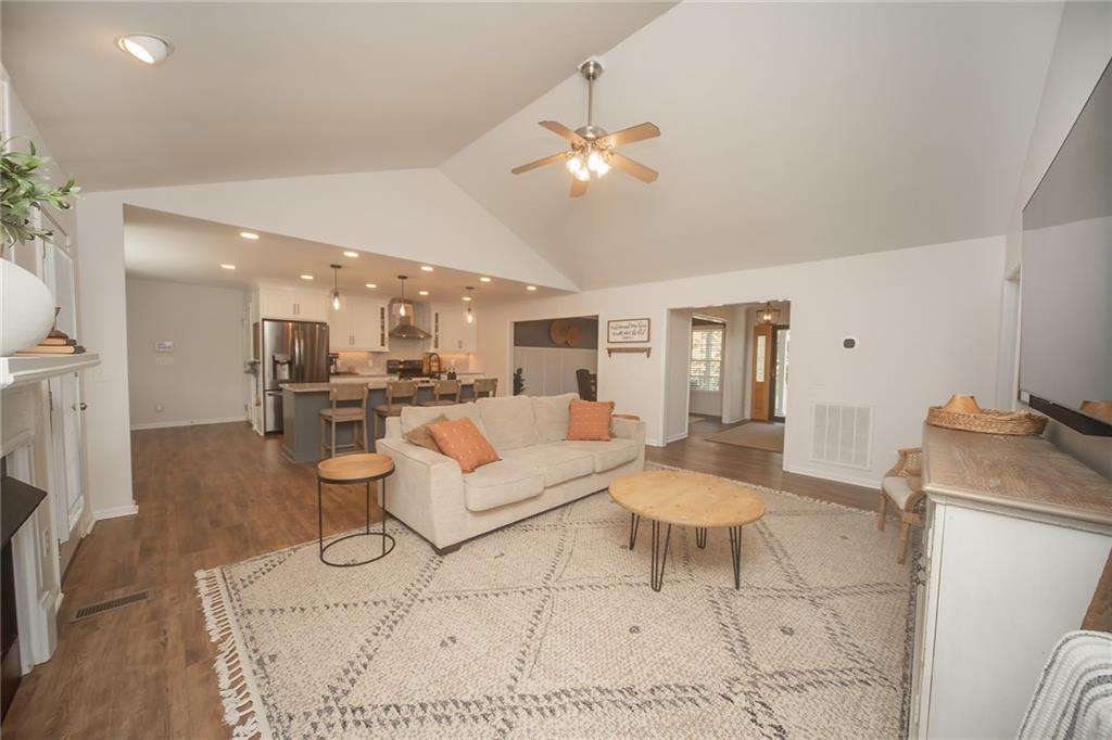 2741 Creek Point Road Graham, NC 27253 - Photo 3 of 36 a living room with furniture and a dining table with kitchen view