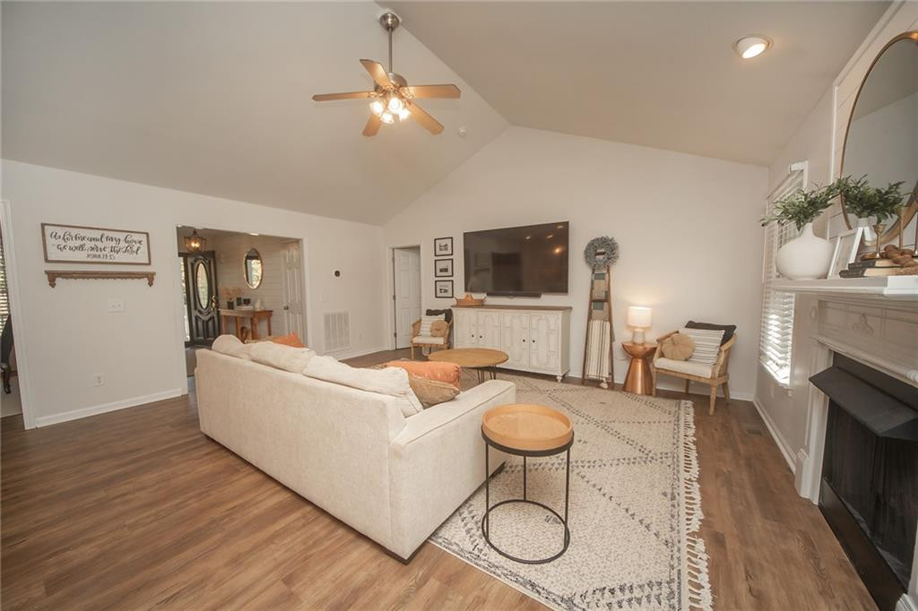 2741 Creek Point Road Graham, NC 27253 - Photo 4 of 36 a living room with furniture a fireplace and a flat screen tv
