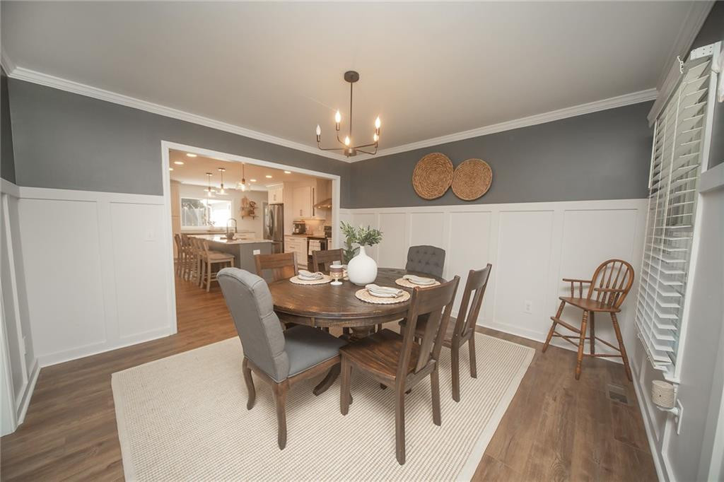 2741 Creek Point Road Graham, NC 27253 - Photo 6 of 36 a view of a dining room with furniture window and wooden floor