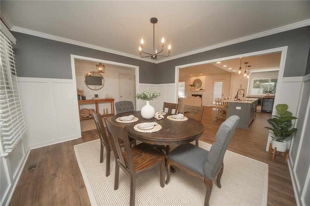2741 Creek Point Road Graham, NC 27253 - Photo 7 of 36 a view of a dining room with furniture and wooden floor