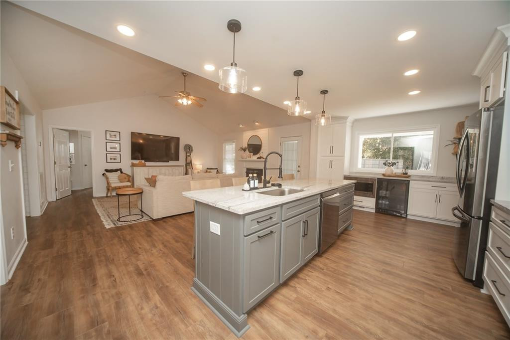 2741 Creek Point Road Graham, NC 27253 - Photo 9 of 36 a large white kitchen with a stove a sink dishwasher and a refrigerator with wooden floor