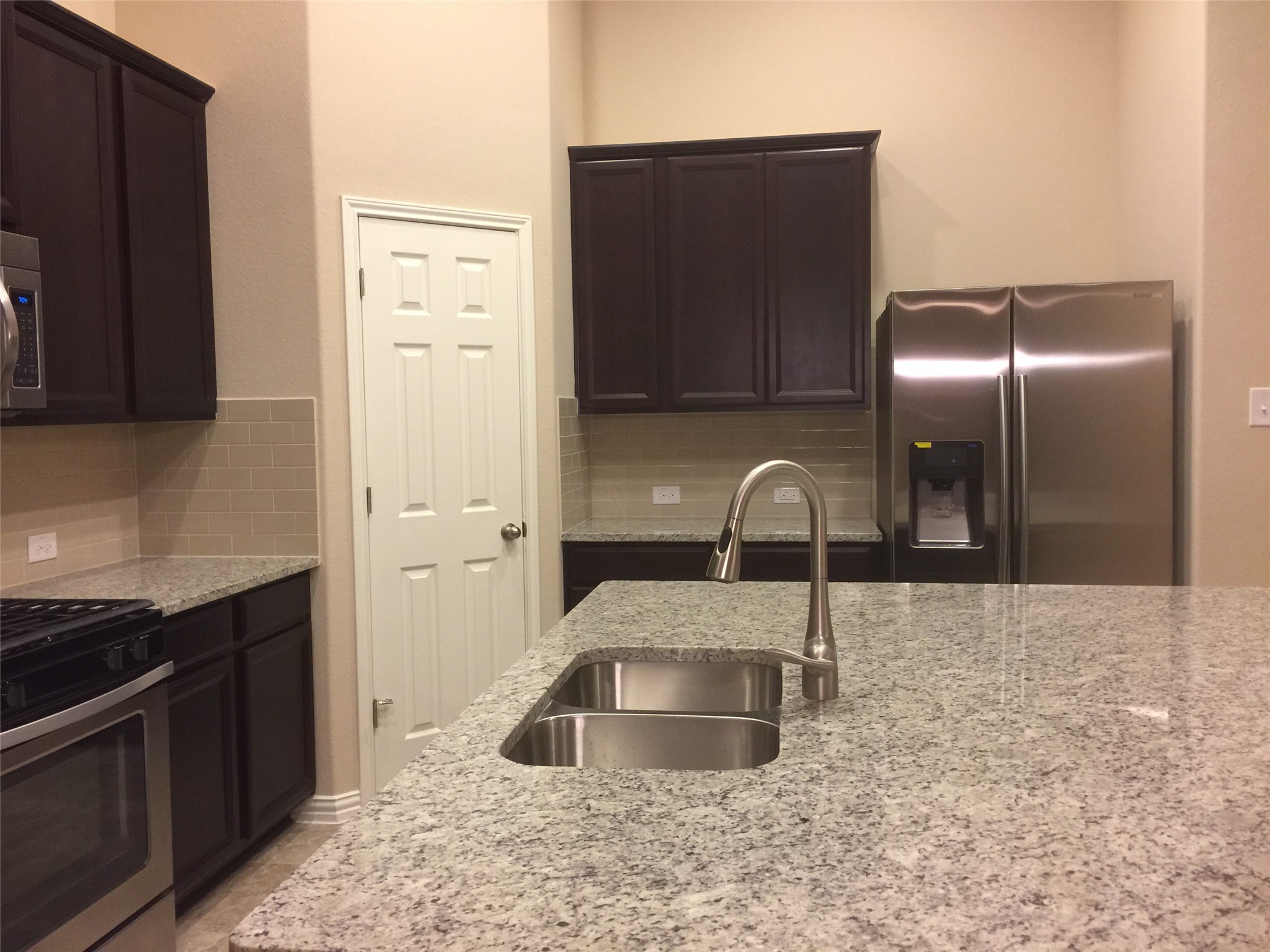 8337 Angelo Loop Round Rock, TX 78665 - Photo 7 of 22 a kitchen with stainless steel appliances a sink and a refrigerator