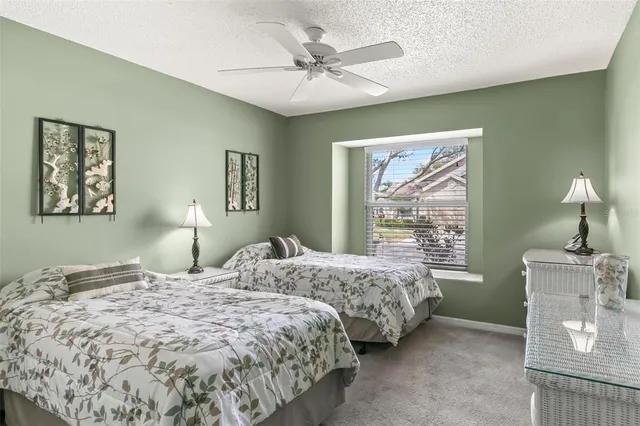 a bedroom with two beds and a chandelier