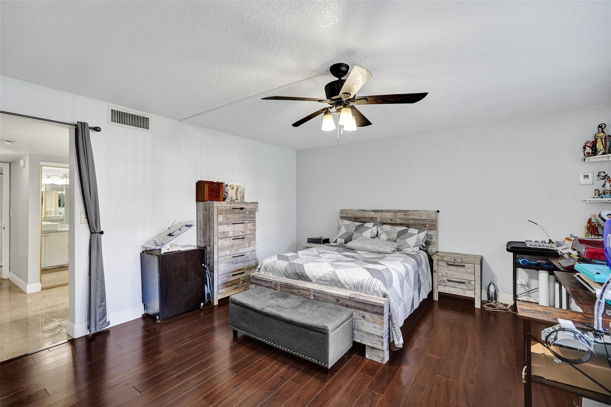 8740 Azalea Court, Unit 102 Tamarac, FL 33321 - Photo 11 of 60 a bedroom with a bed furniture and a flat tv screen