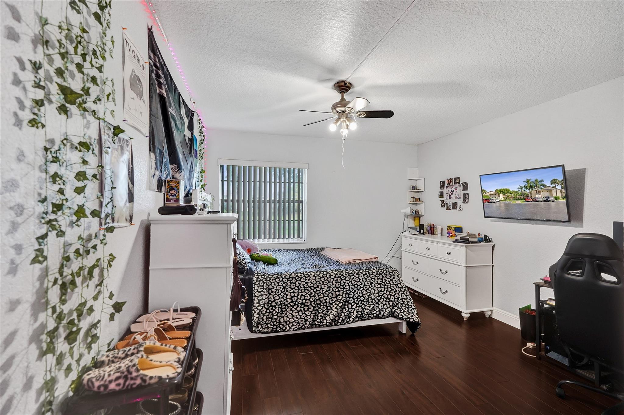 8740 Azalea Court, Unit 102 Tamarac, FL 33321 - Photo 13 of 60 a bedroom with furniture and a chandelier
