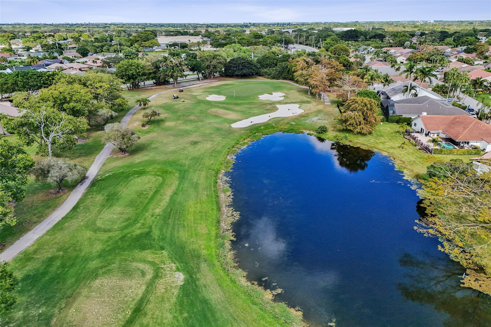 8740 Azalea Court, Unit 102 Tamarac, FL 33321 - Photo 22 of 60 a view of a lush green outdoor space with a lake view