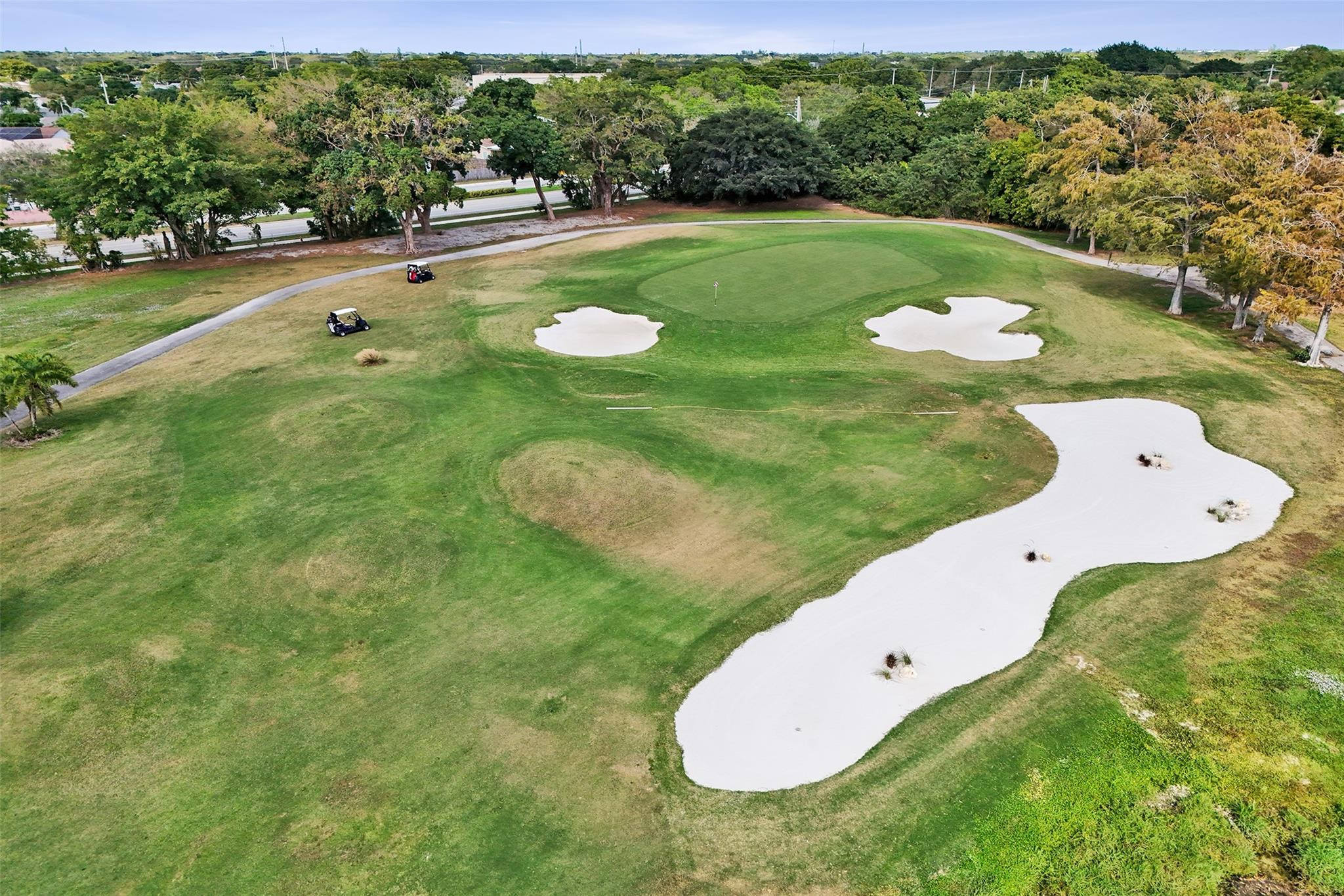 8740 Azalea Court, Unit 102 Tamarac, FL 33321 - Photo 23 of 60 a view of a golf course with a swimming pool