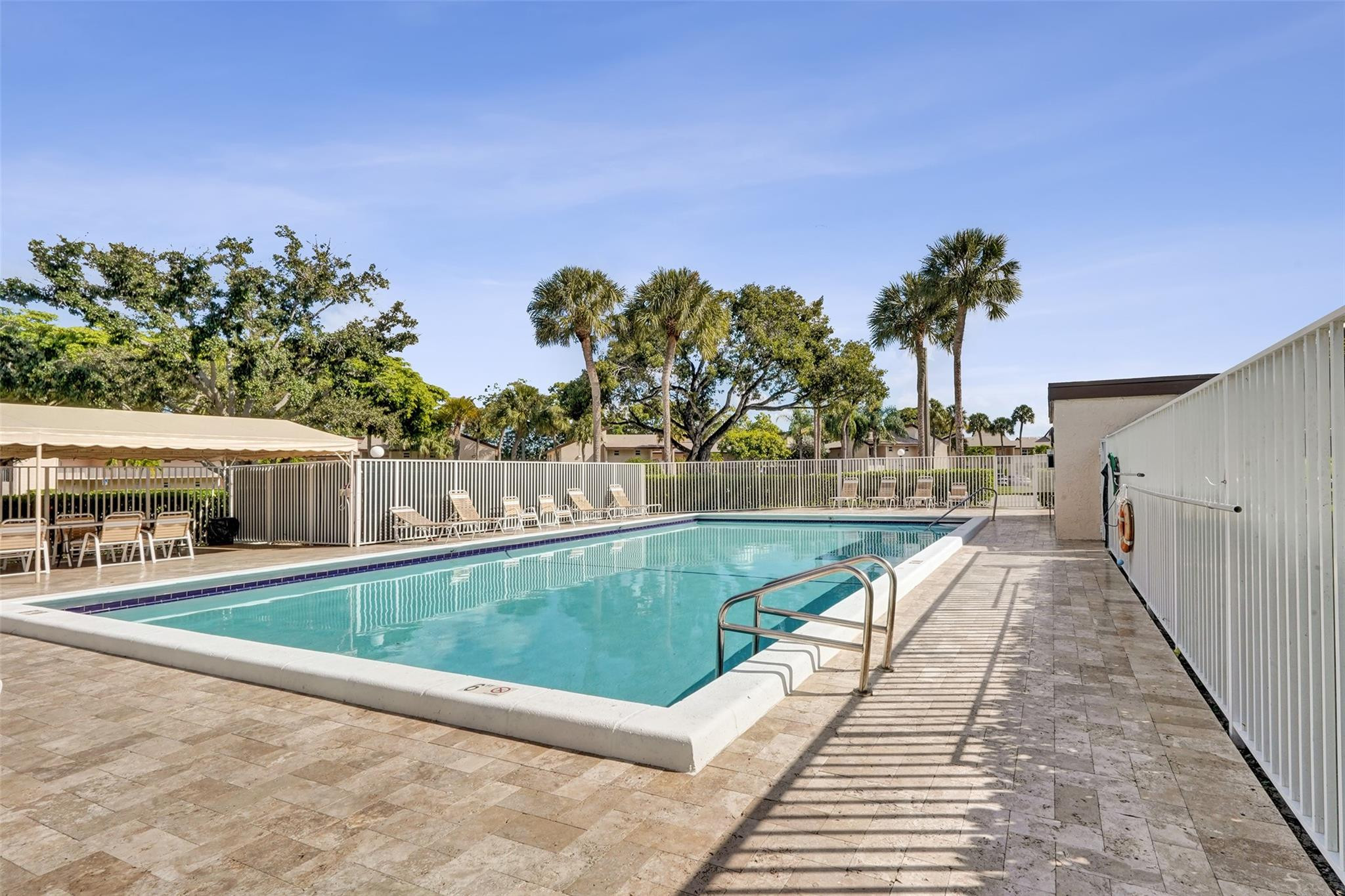 8740 Azalea Court, Unit 102 Tamarac, FL 33321 - Photo 31 of 60 a view of a swimming pool with a patio