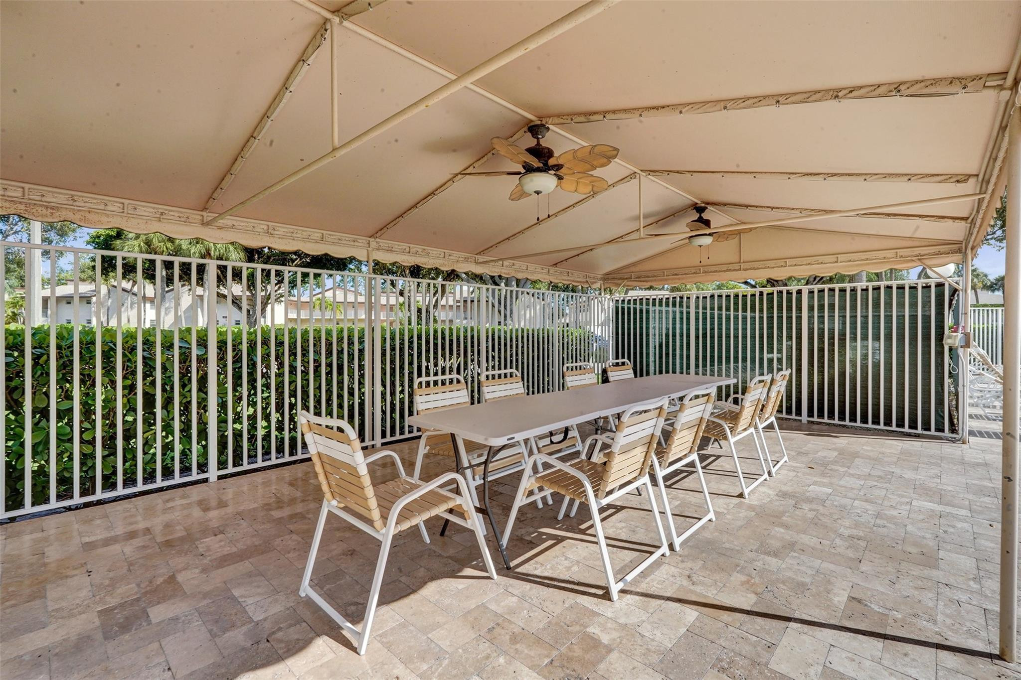 8740 Azalea Court, Unit 102 Tamarac, FL 33321 - Photo 32 of 60 a patio with table and chairs
