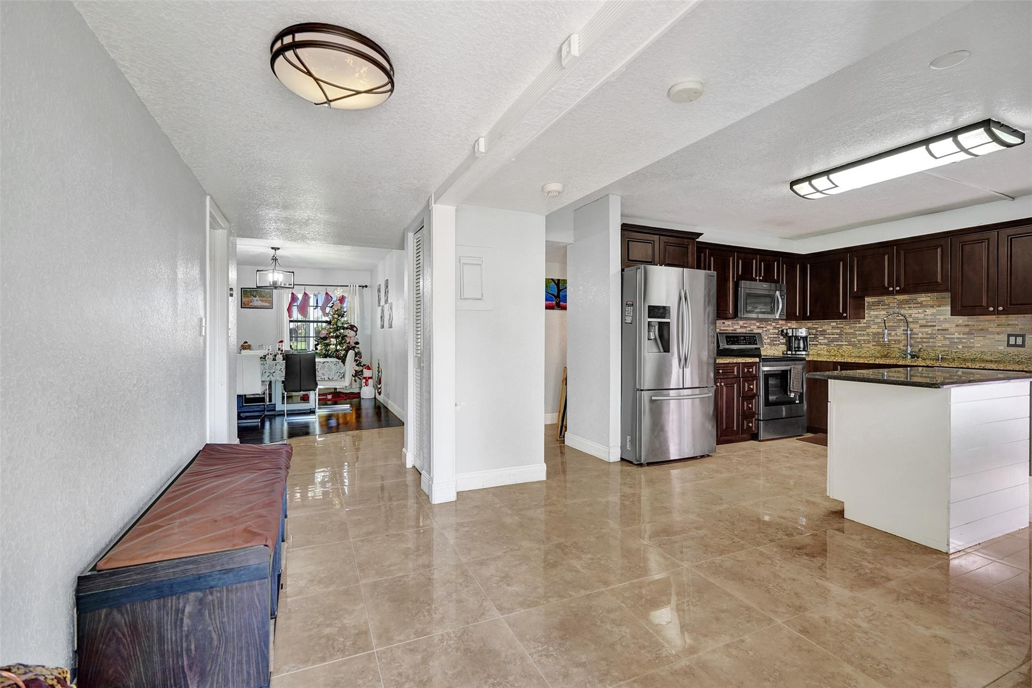 8740 Azalea Court, Unit 102 Tamarac, FL 33321 - Photo 36 of 60 a kitchen with refrigerator and cabinets