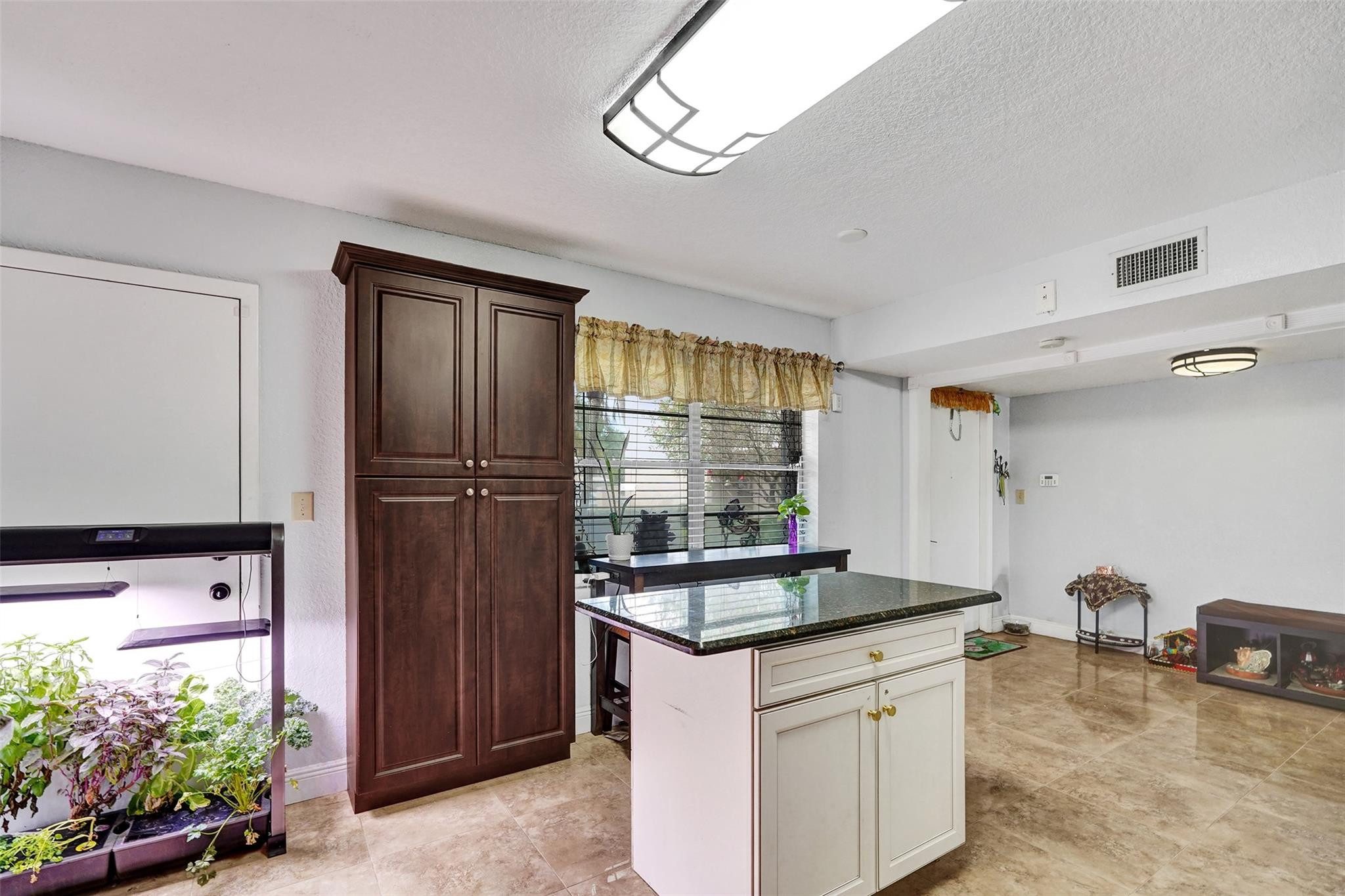8740 Azalea Court, Unit 102 Tamarac, FL 33321 - Photo 40 of 60 a kitchen with granite countertop a refrigerator and a stove