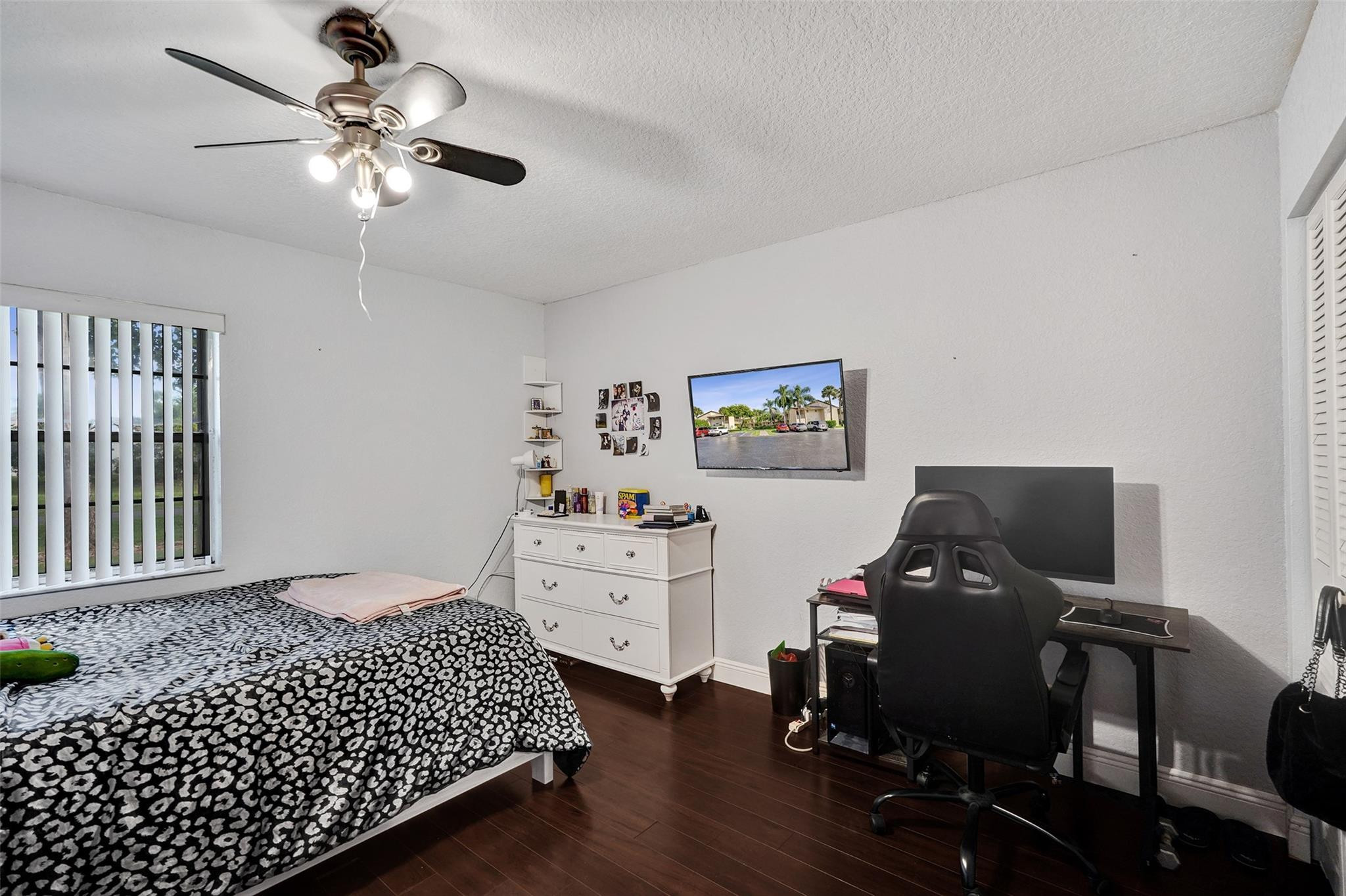8740 Azalea Court, Unit 102 Tamarac, FL 33321 - Photo 45 of 60 a bedroom with a bed and a chandelier