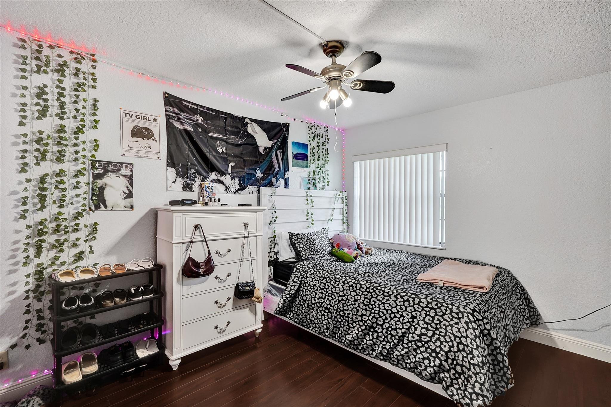 8740 Azalea Court, Unit 102 Tamarac, FL 33321 - Photo 46 of 60 a bedroom with a bed and a chandelier