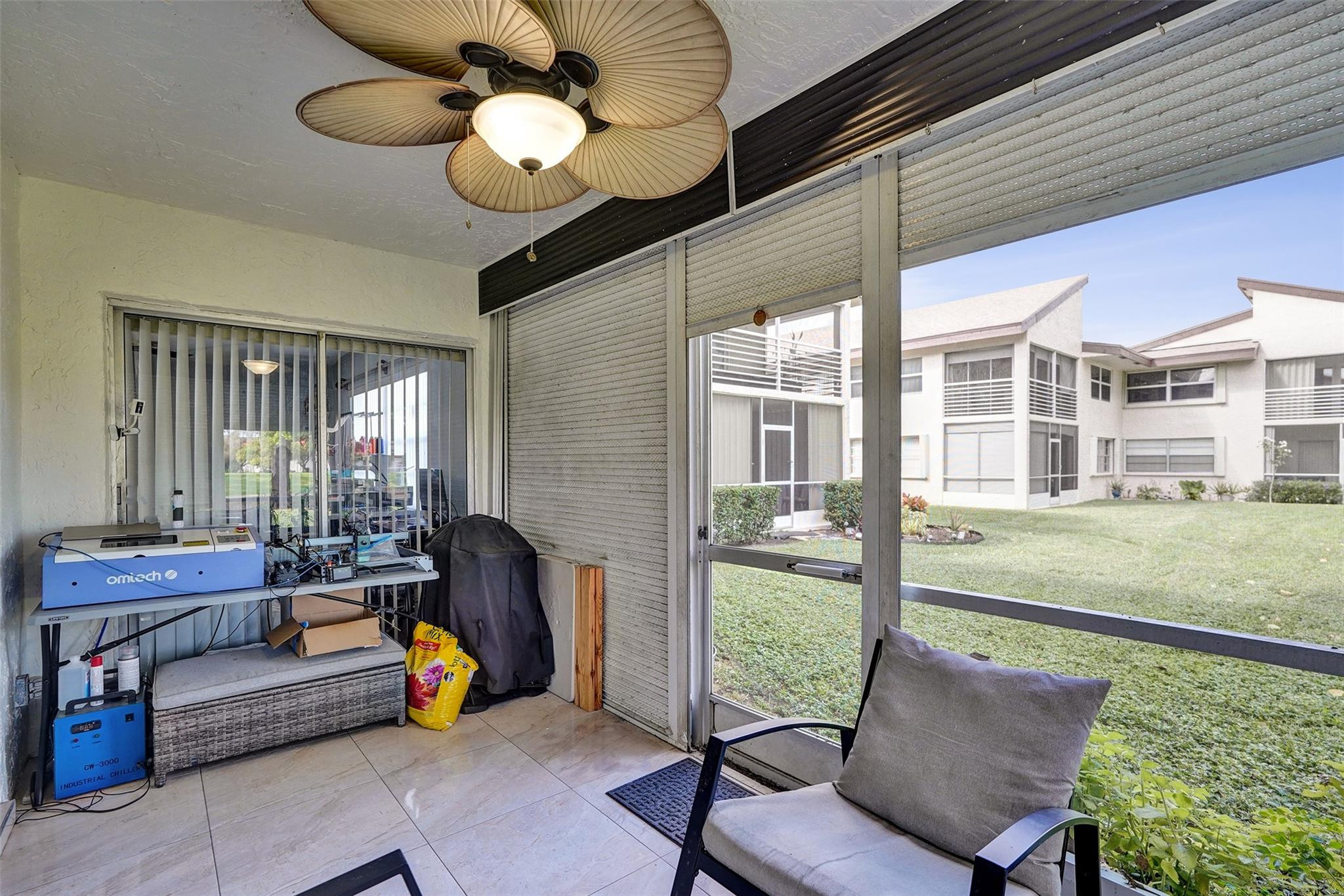 8740 Azalea Court, Unit 102 Tamarac, FL 33321 - Photo 56 of 60 a living room with furniture and a floor to ceiling window