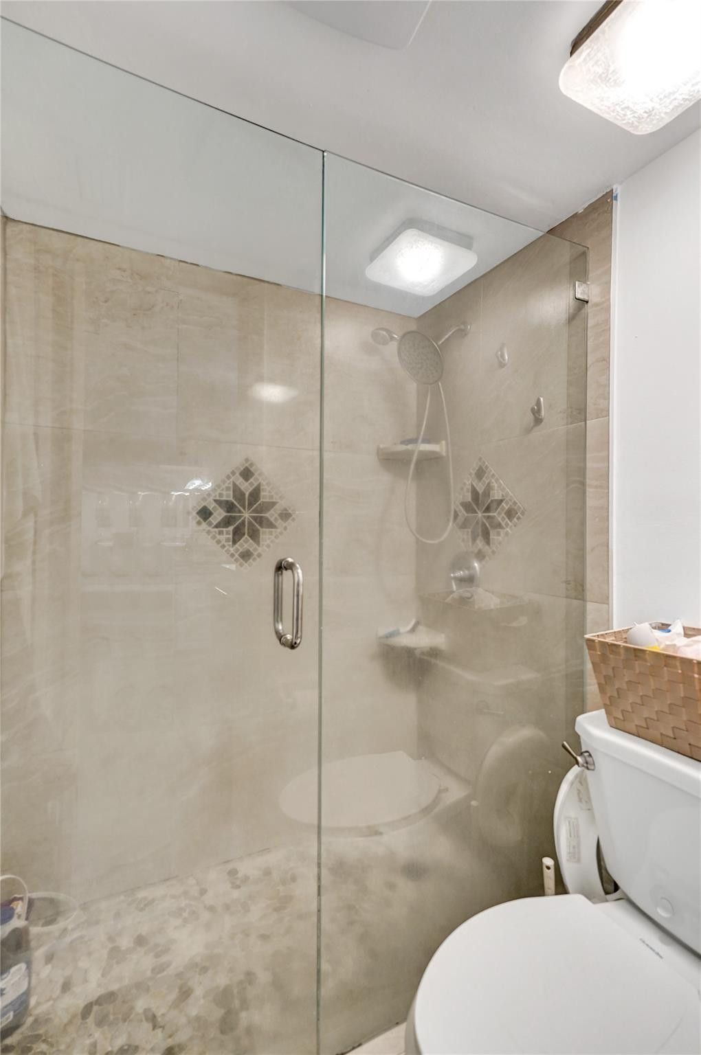 8740 Azalea Court, Unit 102 Tamarac, FL 33321 - Photo 58 of 60 a bathroom with a toilet and a shower