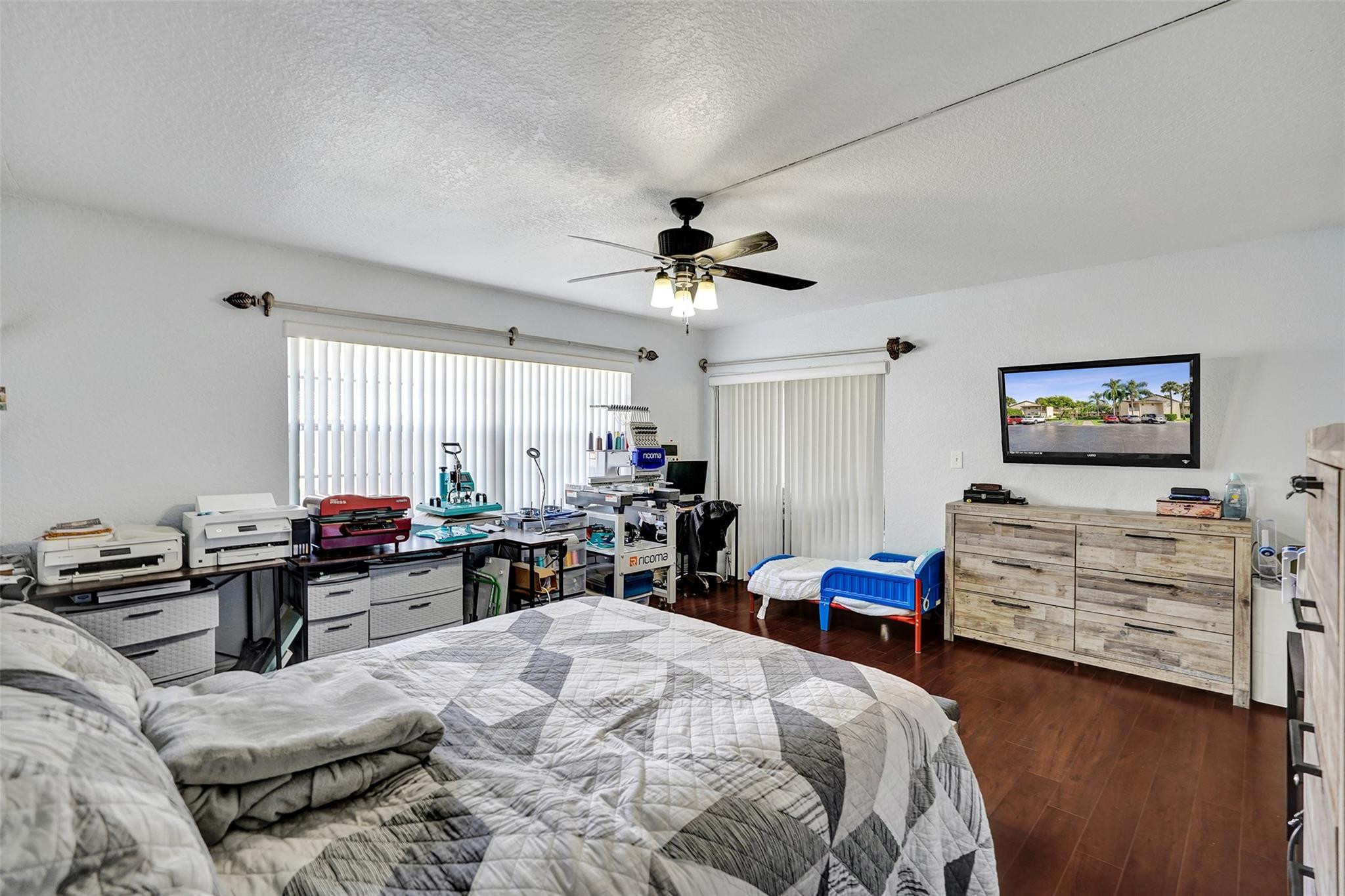 8740 Azalea Court, Unit 102 Tamarac, FL 33321 - Photo 60 of 60 a bedroom with furniture and a chandelier