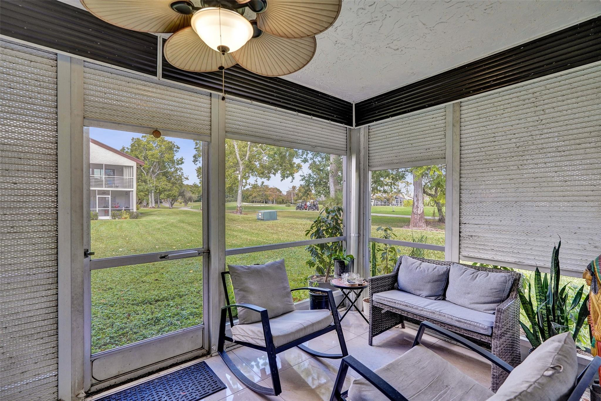 8740 Azalea Court, Unit 102 Tamarac, FL 33321 - Photo 10 of 60 a living room with furniture and a floor to ceiling window