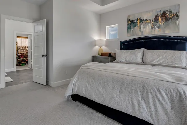 a bedroom with a bed and a chandelier