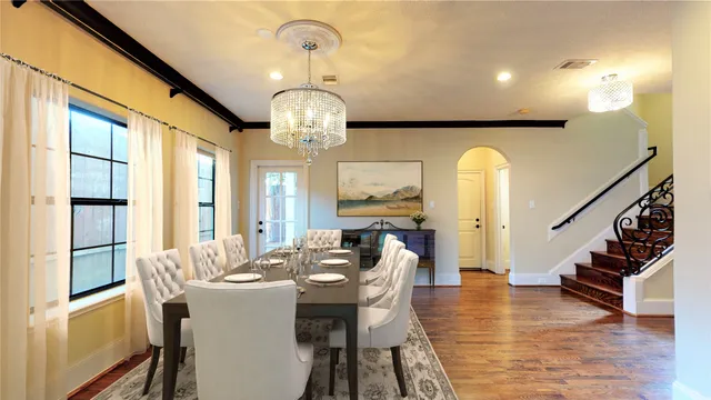 a view of a dining room with furniture wooden floor and chandelier