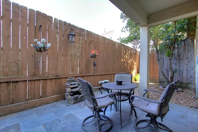 a backyard of a house with table and chairs