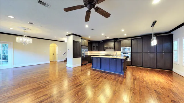 a large kitchen with a large counter top appliances and cabinets