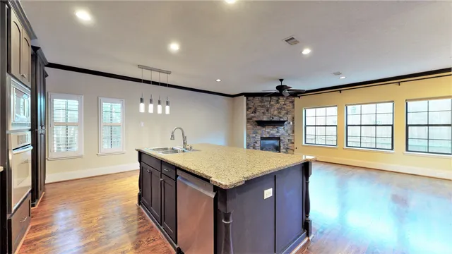 a kitchen with sink and large window