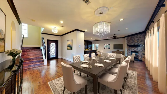 a view of a dining room with furniture wooden floor and chandelier