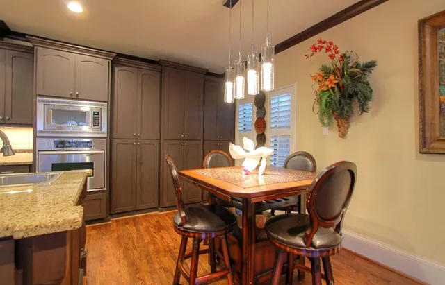a view of a dining room with furniture and a chandelier