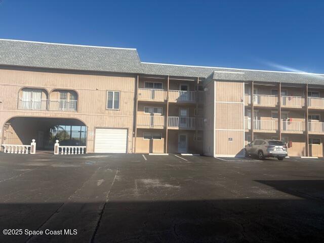 3150 North Atlantic Avenue, Unit 7550 Cocoa Beach, FL 32931 - Photo 2 of 4 a bedroom with a bed and a large window